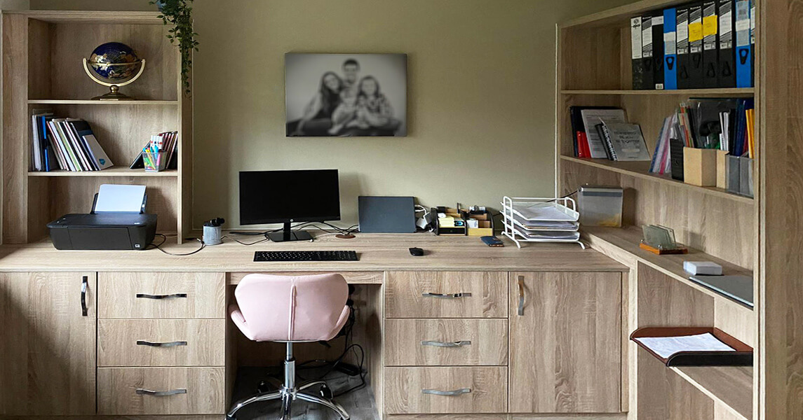 Fitted home office with a fitted desk, drawers, and bookcases in a light oak finish.