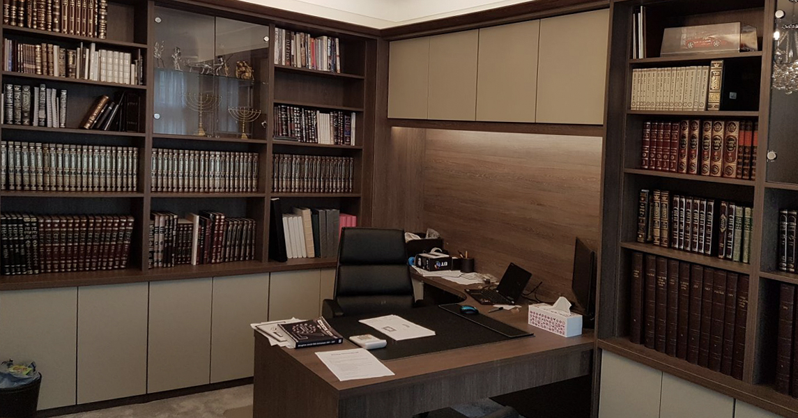 A fitted home office with a desk, fitted bookcase and cupboards in a dark walnut and cream gloss.